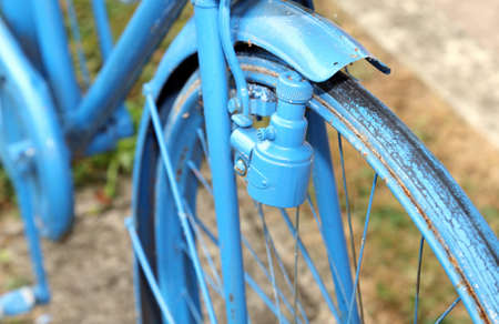 Blue old bicycle with the bottle dynamo device for the headlight on the front wheelの写真素材