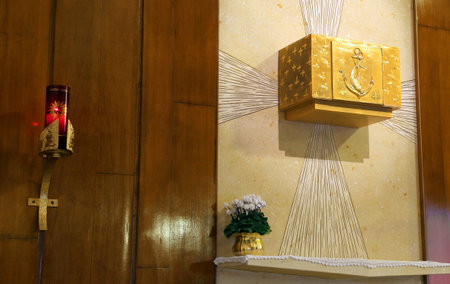 Golden Tabernacle and lighted candle in the Christian Churchの写真素材