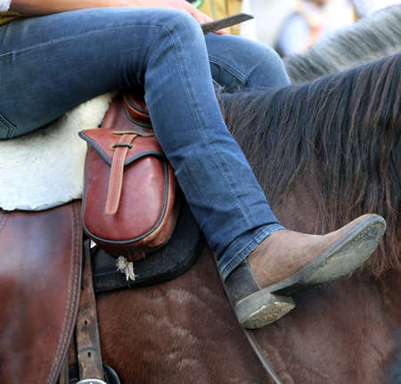 cowboy boots relaxes over the horse's backの写真素材