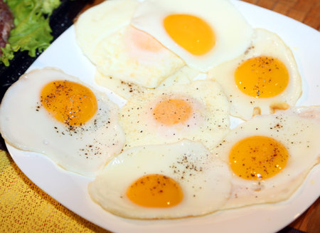 many chicken eggs cooked fried to a hearty breakfast