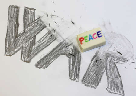 rubber Eraser with written PEACE deletes the black written WARの写真素材