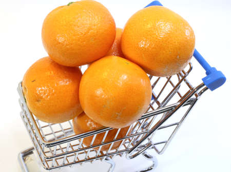 small shopping cart with many clementines and tangerinesの写真素材