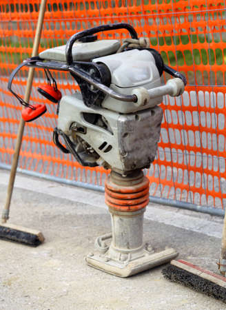 large Compacting plate in a road construction site with safety netの写真素材