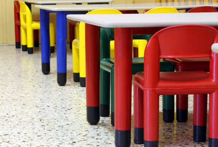 small colored tables and chairs in the refectory of the kindergartenの写真素材