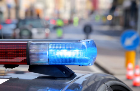 blue flashing police car during a roadblock to hunt down the escaped prisoners
