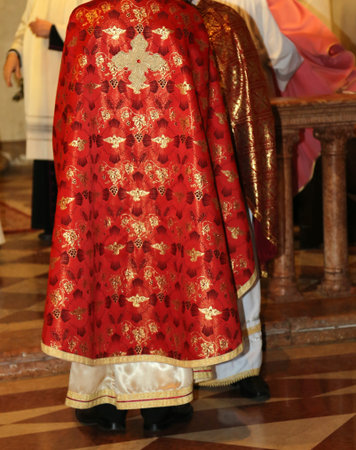 priests with pink cassock in church during the celebration of Mass