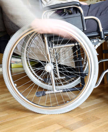 hand of the young disabled in the wheel of the wheelchairの写真素材