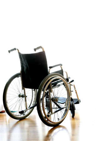 wheelchair for transport of disabled people on the bedroom in front of the windowの写真素材