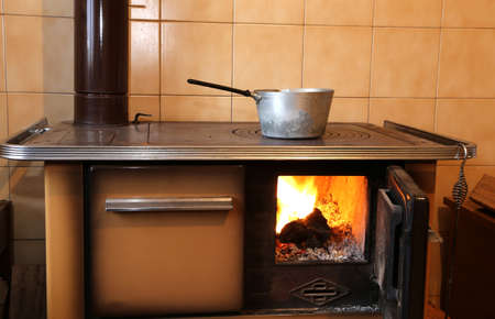 old wood-burning stove in the kitchen of homeの写真素材