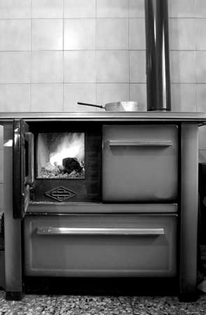 old wood-burning stove in the kitchen of mountain homeの写真素材
