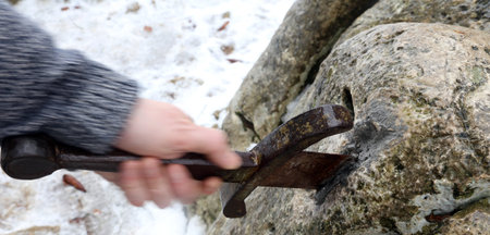 Hand of the valiant knight in moviment tries to remove the magical Excalibur sword in the stoneの写真素材
