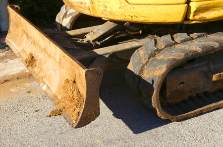 small bucket of a yellow Digger in road construction