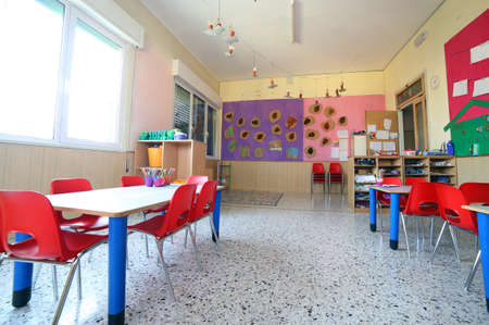 inside of the kindergarten classroom with drawings on the wallsの写真素材