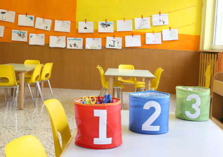 Red Green and blue jars with large lettering one two and three on the table in the kindergarten classの写真素材