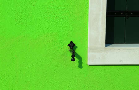 green wall with the stop balcony system with the shape of man and woman of an Italian homeの写真素材