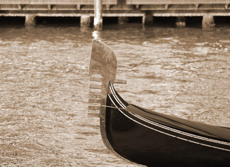 old Venetian gondola sailing the sea sepia effectの写真素材