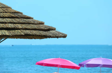 Beach with parasols made with bamboo and straw in the luxurious resortの写真素材