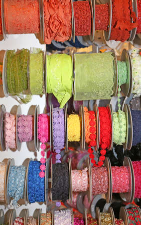 many colored ribbons and decorative rolls for sale per meter in the wholesaler's shop of articles for hobbyistsの写真素材