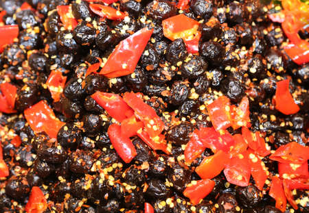 Southern Italian dish with black olives and Sun-dried tomatoes into small pieces with olive oilの写真素材