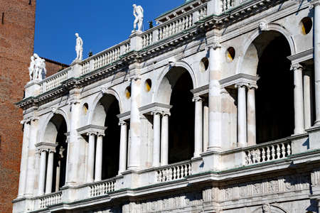 Vicenza, Italy. Ancient Tower called Basilica Palladiana in the main square of the city and blue sky with moving cloudsの写真素材