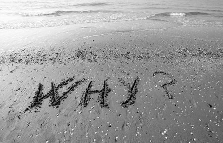 Great inscription written on the sand of the sea with the words WHY