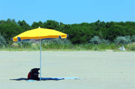 block yellow umbrella on the sunny beach in summer without anyの写真素材