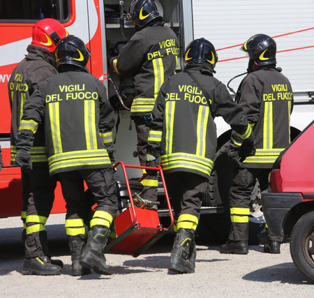 Group of firefighters working as a perfect teamwork during an emergency