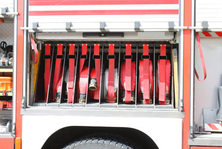 big red fire truck hoses fighting services in fire truck during the fire emergency