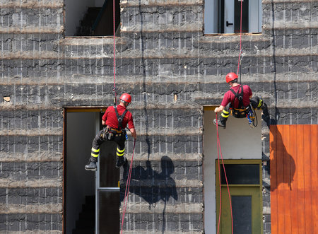 bold and daring climbers of firefighters climbing a wall