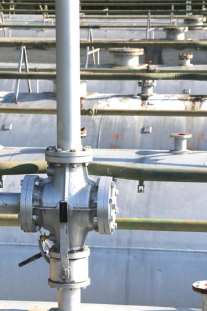 big ball valve above the huge gas cylinder in the system of natural gas storage in the industrial...