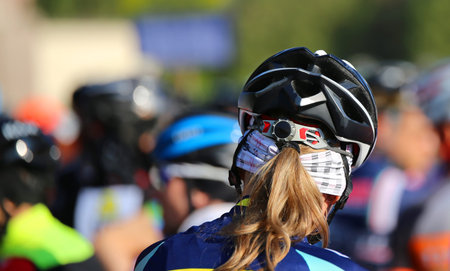 blonde female Cyclist safety helmet during the start of the cycling raceの写真素材