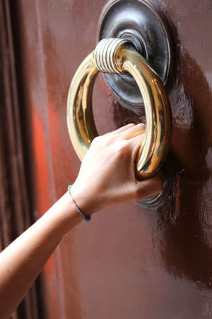 baby hand knocking at the closed doorの写真素材