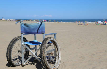wheelchair aluminum on the sand of the beach in summerの写真素材