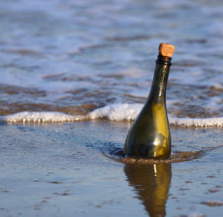 Message in the glass bottle on the beachの写真素材