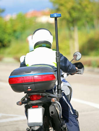 police motorbike with blue siren on the roadの写真素材