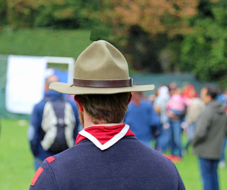 scout leader at international gathering in uniform with campaign hat and scarf red and whiteの写真素材