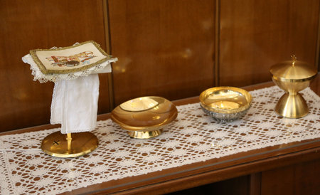 golden chalice and paten for Holy Communion during the Mass of the Catholic religious ceremony