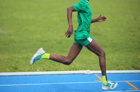 Young African athlete won the foot race with long stepsの写真素材