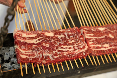 delicious kebabs of lamb kebabs cooking on hot coalsの写真素材