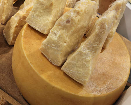 many pieces Italian Parmesan cheese for sale in the dairyの写真素材