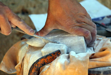 hand of an expert craftsman and stone sculptingの写真素材