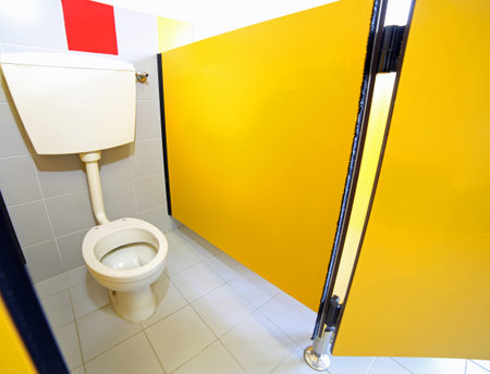 small toilet without toilet paper roll in the bathroom of a kindergarten for children