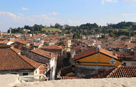 panorama roofs from above of a European city with the hills on backgroundの写真素材