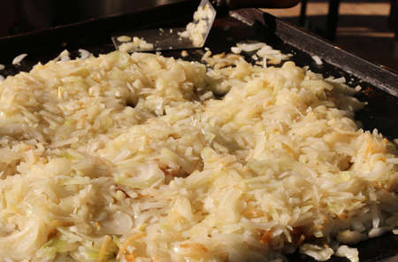 cooked onions in the grilled plate in a fast food storeの写真素材