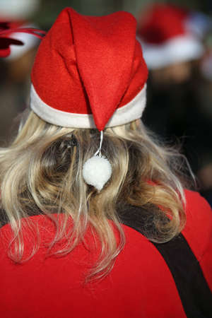blonde woman with long hair and a Santa Claus hatの写真素材