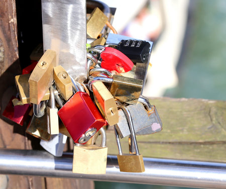 many padlocks of lovers installed on the city bridge