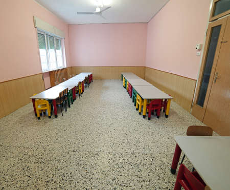 classroom nursery with small benches and colorful plastic chairsの写真素材
