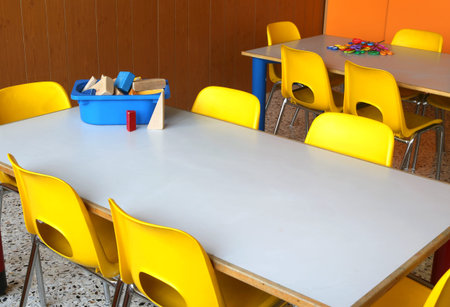tables and chairs in the classroom of kindergarten without childrenの写真素材