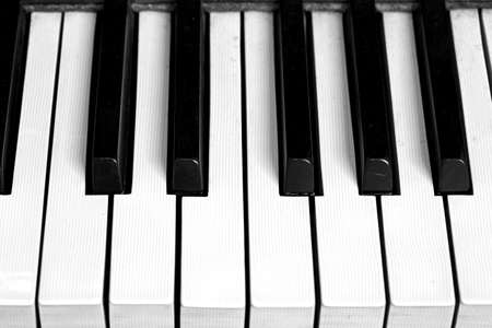 detail of a piano keyboard with blacks and white keysの写真素材