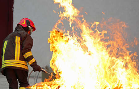 fireman during a training exercise off a huge fire in the brazierの写真素材